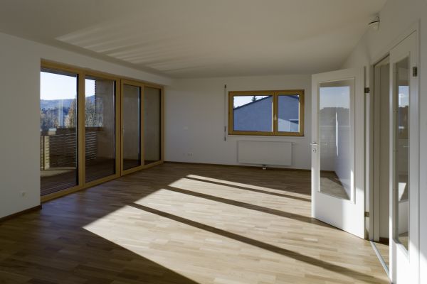 Leerer Innenraum des Holz-Passivhauses am Mühlweg mit Glastüren und Fenster